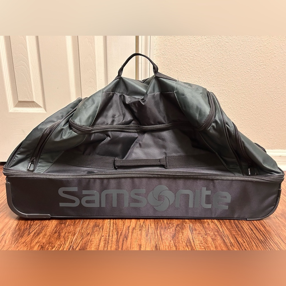 Brand new Samsonite travel bag, green/black, with handle and wheels.